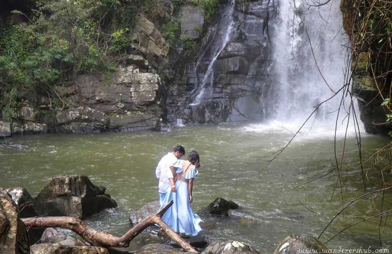 couple post at waterfall